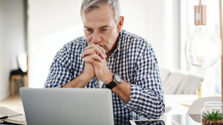Older man sitting at a laptop