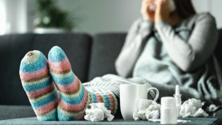 Sick woman surrounded by tissues