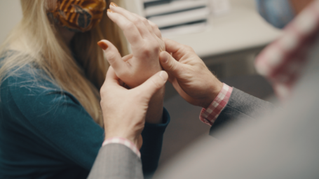 Orthopaedic physician looking at hand injury